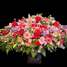 Pinks and lilac casket spray